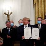 President Donald Trump poses for a photo during a signing ceremony for H.R. 1957 – The Great American Outdoors Act, in the East Room of the White House on Tuesday, Aug. 4, 2020, in Washington. (Alex Brandon/The Associated Press)