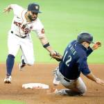Houston Astros second baseman Jose Altuve, left, catches Seattle Mariners Evan White trying to steal in the top of the seventh inning Sunday, Aug. 16, 2020, in Houston. (Kevin M. Cox/The Galveston County Daily News via AP)