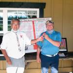Port Townsends Gabriel Tonan, right, accepts medalist honors as Washington State Hickory Golf Tournament Champion from Martin Pool of the Northwest Hickory Players after he won the event at Trophy Lake Golf & Casting Club in Port Orchard on Saturday, Aug. 15, 2020.