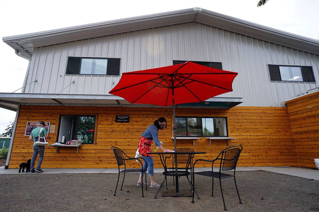Ashley Avery of The Guerrilla Kitchen takes orders Friday at a walk-up window at Lilas Kitchen in Port Townsend. On Fridays, The Guerrilla Kitchen shares the new commercial kitchen space with Mo-Chilli BBQ, each serving customers through separate walk-up windows. (Nicholas Johnson/Peninsula Daily News)