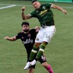 Portland Timbers midfielder Marvin Loria, right, goes up for the ball against Seattle Sounders midfielder Joao Paulo, left, during the first half of an MLS soccer match in Portland, Ore., Sunday, Aug. 23, 2020. (AP Photo/Steve Dykes)