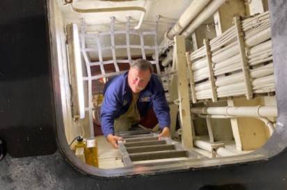 John Johnson climbs one of the many ladders inside the USS Essex earlier this month. He and Dave Richardson of Diamond Point rode to Oahu to fly Johnsons T6 Texan in a special event honoring the end of World War II. (Photo courtesy of John Johnson)                                John Johnson climbs one of the many ladders inside the USS Essex earlier this month.