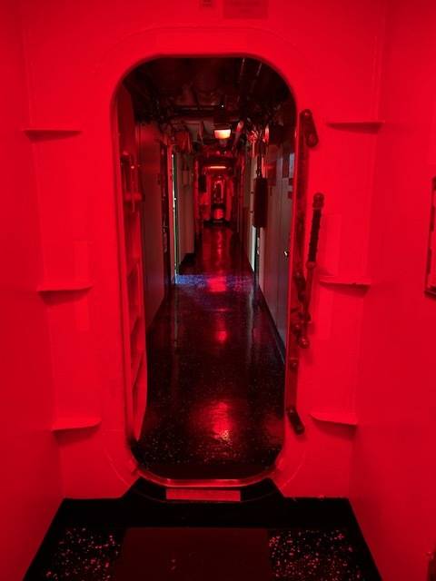 At sundown, lights turn to red aboard the USS Essex to preserve night vision for crewmen. (Photo courtesy of John Johnson)