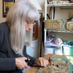 Ellen Cote cuts fabric for face masks at her home in Port Townsend. (Ellen Cote)