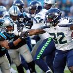 Seattle Seahawks running back Chris Carson (32) runs while Carolina Panthers defensive back Ross Cockrell (47) chases during the second half of an NFL football game in Charlotte, N.C., on Sunday, Dec. 15, 2019. (Brian Blanco/Associated Press file)