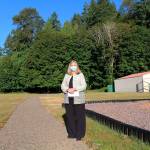 Brinnon School District Superintendent Trish Beathard stands on the districts new walking/running path that was installed over late spring and summer with funding received from a state grant. To her right is the upgraded play area that the district completed last summer with a separate grant award from the same state funding source. (Zach Jablonski/Peninsula Daily News)