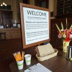 A sign, flowers, hand sanitizer and bagged face masks greet visitors to the Jefferson Museum of Art & History on Saturday, the museums first day open since it closed in March due to the growing coronavirus pandemic. (Nicholas Johnson/Peninsula Daily News)