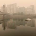 A view of downtown Portland from the East Bank Esplanade is seen Monday, Sept. 14, 2020. The entire Portland metropolitan region remains under a thick blanket of smog from wildfires that are burning around the state and residents are being advised to remain indoors due to hazardous air quality. (Gillian Flaccus/Associated Press)