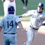 Seattle Mariners Dylan Moore (25) is congratulated by Manny Acta (14) after hitting a two-run home run against the San Diego Padres on Sunday, Sept. 20, 2020, in San Diego. (Denis Poroy/Associated Press)