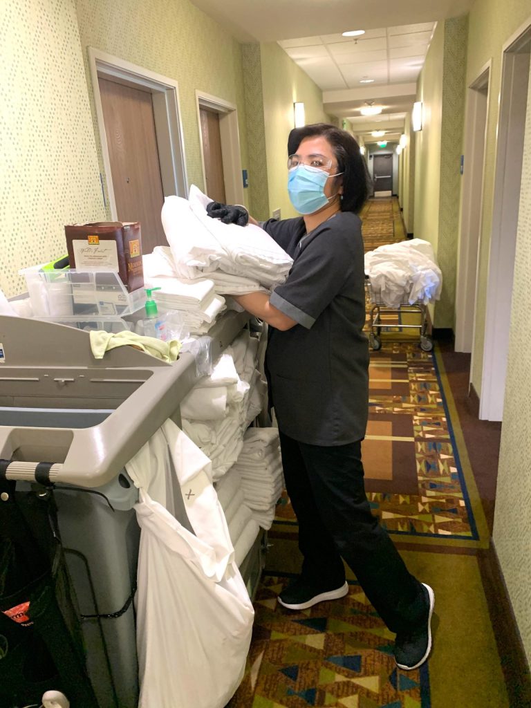 Ru Bi Boyd readies towels for rooms at the Sequim Holiday Inn Express & Suites. Less towels are being placed in rooms and even unused towels and bedding are being cleaned to prevent the spread of COVID-19, say staff. (Photo courtesy of Namaste Cousins)