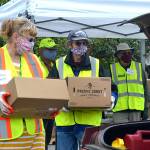 Volunteers Nancy Elwert and Bruce Leigh with Community Emergency Response Teams (CERT) ready to place food boxes in a trunk on June 10 at Sequim High School. The program, now held at Trinity United Methodist Church, continues twice monthly through December. Matthew Nash/Olympic Peninsula News Group