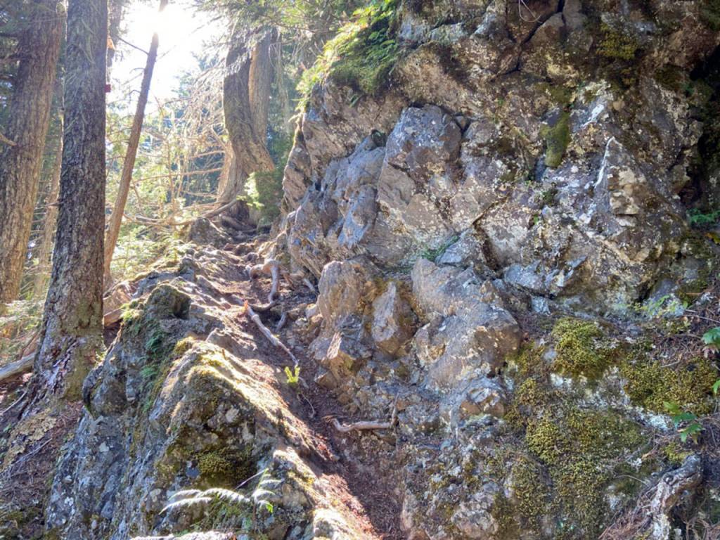 A rock ledge leads the way to Lake Constance. (Rob Ollikainen/Peninsula Daily News)