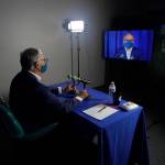 Washington Gov. Jay Inslee, a Democrat, takes part in a sound check in the room he will be in for his debate with Republican Loren Culp, Wednesday, Oct. 7, 2020, in Olympia, Wash. Due to concerns over COVID-19, each candidate will be taking part in the debate from individual rooms separate from moderators. (Ted S. Warren/Associated Press)