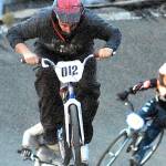 Keith Thorpe/Peninsula Daily NewsAaron Petersen (012) of Port Angeles leads Sam Brown (078) of Port Angeles in the novice category at the Lincoln Park BMX Track on Thursday night under the track's new lights. The track is back open for competition.