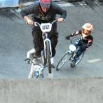 Keith Thorpe/Peninsula Daily News Aaron Petersen (012) of Port Angeles leads Sam Brown (078) of Port Angeles in the novice category at the Lincoln Park BMX Track on Thursday night under the tracks new lights. The track is back open for competition.