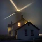 The New Dungeness Lighthouse, pictured here shining light through a thick fog, got some TLC this summer from volunteers. The light stations museum and light tower remain closed to the public Photo by Ben Wasson