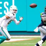 Seattle Seahawks running back Chris Carson (32) catches the ball in front of Miami Dolphins linebacker Kyle Van Noy (53) during an NFL football game, Sunday, Oct. 4, 2020, in Miami Gardens, Fla. (AP Photo/Doug Murray)