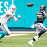 Seattle Seahawks running back Chris Carson (32) catches the ball in front of Miami Dolphins linebacker Kyle Van Noy (53) during an NFL football game, Sunday, Oct. 4, 2020, in Miami Gardens, Fla. (AP Photo/Doug Murray)