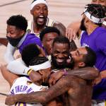 Los Angeles Lakers' LeBron James (23) celebrates with his teammates after the Lakers defeated the Miami Heat 106-93 in Game 6 of basketball's NBA Finals Sunday, Oct. 11, 2020, in Lake Buena Vista, Fla. (AP Photo/Mark J. Terrill)