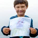 Jefferson County first-grader Henry Norris shows off his winning drawing in Gov. Jay Inslee's contest to find and draw a kraken in the Salish Sea. Inslee announced the contest the day the new Seattle NHL hockey franchise introducted its Kraken nickname.  Seattle Kraken