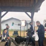 Jefferson County first-grader Henry Norris and his dad, Chad, are interviewed by a Seattle Kraken production team after Henry won Gov. Jay Inslees contest to find and draw a kraken in the Salish Sea. Norris earned a lifetime pass on the Washington State Ferry system and gear from the Seattle Kraken. (Katy Norris)
