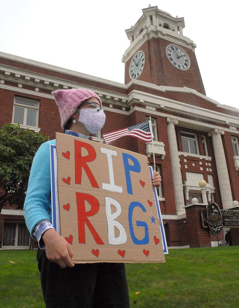 Keith Thorpe/Peninsula Daily NewsHarmony Rutter of Sequim holds a sign honoring the late Supreme Court Justice Ruth Bader Ginsberg in front of the Clallam County Courthouse in Port Angeles on Saturday.