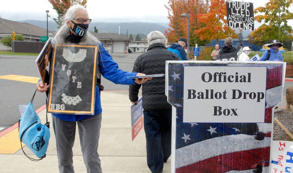 Keith Thorpe/Peninsula Daily NewsSandy Ulf of Port Angeles drops off ballots after attending a rally for late Supreme Court Justice Ruth Bader Ginsberg on Saturday atd the Clallam County Courthouse.