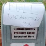 Keith Thorpe/Peninsula Daily NewsA sign over the delivery slot warns drive-up voters that one of two official ballot boxes drop-off boxes in front of the Clallam County Courhouse was filled to the top on Saturday.