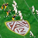 FILE - In this Aug. 29, 2019, file photo, is the Pac-12 logo during the second half of an NCAA college football game between Arizona State and Kent State, in Tempe, Ariz. The return of football isn't likely to make much of a dent in the losses athletic departments across the Pac-12 will ultimately incur because of the coronavirus pandemic. Faced with dramatic budget shortfalls, most schools in the league have already resorted to layoffs, furloughs, and cutting some sports entirely. (AP Photo/Ralph Freso, File)
