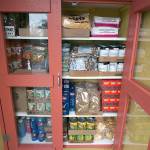 A pantry outside the Port Townsend Food Bank is stocked with non-perishable food items free for the taking at the corner of Blaine and Walker streets in Port Townsend. (Nicholas Johnson/Peninsula Daily News)