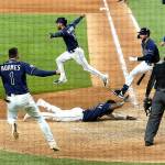 Tampa Bay players celebrate winning in Game 4 of the baseball World Series Saturday night in Arlington, Texas. Rays defeated the Dodgers 8-7 to tie the series 2-2 games. (AP Photo/Eric Gay)