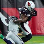 Seattle Seahawks wide receiver DK Metcalf tackles Arizona Cardinals strong safety Budda Baker (32) short of the goal line after Baker intercepted a pass during the first half of an NFL football game, Sunday, Oct. 25, 2020, in Glendale, Ariz. (AP Photo/Rick Scuteri)