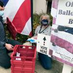 Paul Gottlieb/Peninsula Daily News
Clallam County election workers Ame Cochnauer, right, and Thomas Newton, did their second of at least three ballot pickups Monday from two drop-off boxes outside the courthouse that hold a combined 1,200 ballots.