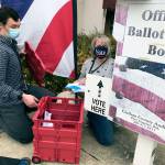 Clallam County election workers Ame Cochnauer, right, and Thomas Newton did their second of at least three ballot pickups Monday, Oct. 26, 2020, from two drop boxes outside the Clallam County Courthouse that hold a combined 1,200 ballots. (Paul Gottlieb/Peninsula Daily News)