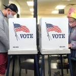 Danny Romero, left, and Petal Ruch, both of Port Angeles, fill out ballots at portable polling stations at the Clallam County Courthouse in Port Angeles on Election Day. (Keith Thorpe/Peninsula Daily News)