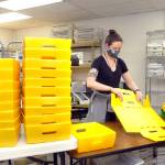 Clallam County election worker Nicole Mischke folds ballot trays at the Clallam County Courthouse on Tuesday in anticipation of an influx of ballots on Election Day. (Keith Thorpe/Peninsula Daily News)