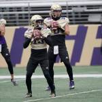 Washington quarterbacks Jaden Sheffey, center, Kevin Thomson, left, and Jacob Sirmon, right, pass in a group during NCAA college football practice, Friday, Oct. 16, 2020, in Seattle. (AP Photo/Ted S. Warren)