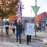Tim Wheeler and Lisa Dekker help lead a group of about 40 individuals in a rally and walk in downtown Sequim on Wednesday afternoon to promote the counting of all ballots in the 2020 general election. (Michael Dashiell/Olympic Peninsula News Group)
