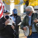Tim Wheeler, left, and a group of about 40 individuals sing Woody Guthries This Land Is Your Land, accompanied by Steve Koehler on banjo, at the Sequim Civic Center on Wednesday afternoon. (Michael Dashiell/Olympic Peninsula News Group)