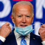 Democratic presidential candidate former Vice President Joe Biden takes off his face mask as he arrives to speak Wednesday, Nov. 4, 2020, in Wilmington, Del. (Carolyn Kaster/Associated Press)