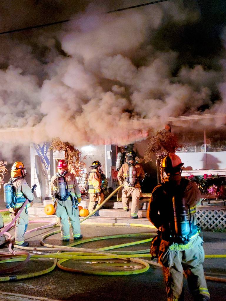 Firefighters battle a blaze at the Nordland General Store in the early morning hours Thursday as smoke billows out of the building at 7180 Flagler Road on Marrowstone Island. The inside of the building suffered heavy damage from smoke and heat, said Brian Tracer, assistant chief with East Jefferson Fire Rescue. (Photo courtesy of Leah Speser)