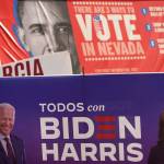 A campaign sign supporting Democratic presidential candidate former Vice President Joe Biden and running mate Kamala Harris stands in front of a vote sign showing former President Barack Obama near the Clark County Election Department in North Las Vegas, Nev., Friday, Nov. 6, 2020. (AP Photo/Jae C. Hong)
