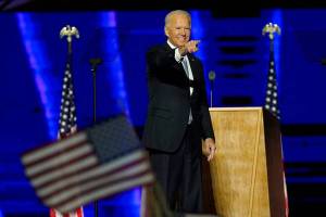 President-elect Joe Biden gestures on stage after speaking, Saturday, Nov. 7, 2020, in Wilmington, Del. (AP Photo/Andrew Harnik, Pool)