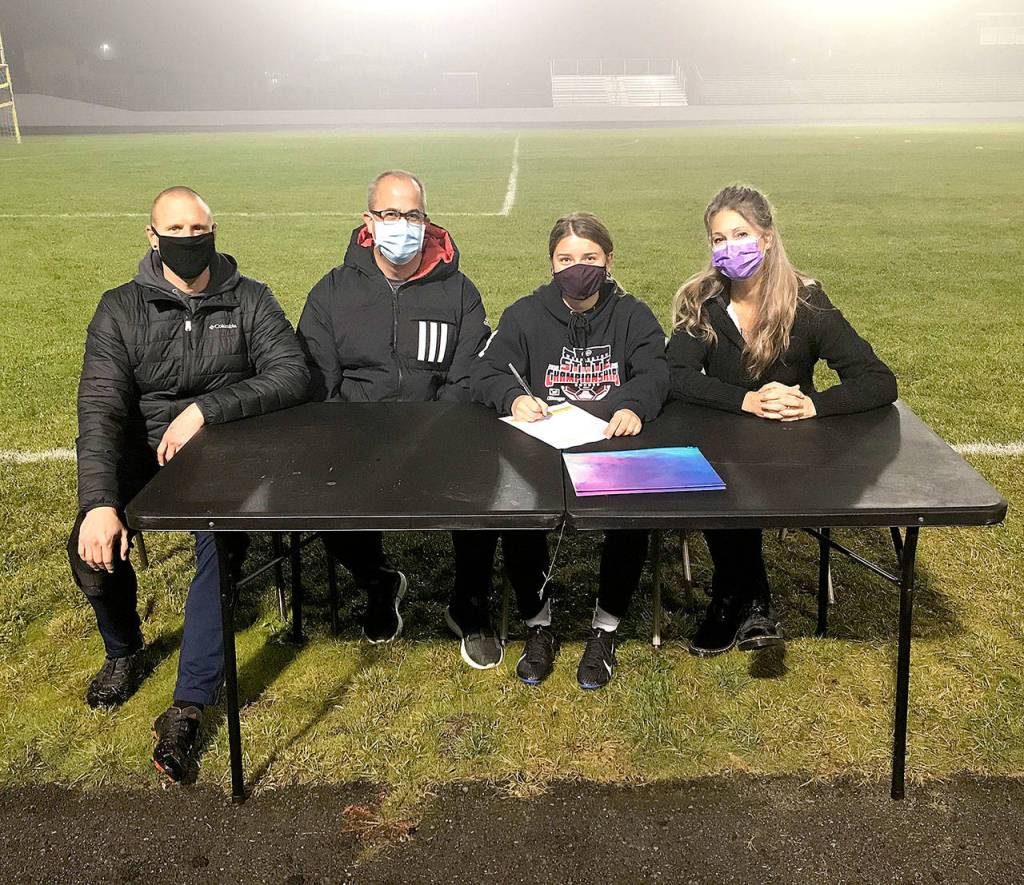 Natalya James is shown signing her letter of intent with coach Derek VanderVelde (left) and parents Jimmy and Heidi James.