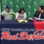 Port Angeles' Jada Cargo signs a letter of intent to play softball for Lower Columbia Community College. Cargo is joined by her stepdad Jeremy Acosta, left, and mother, Vashti White-Acosta.
