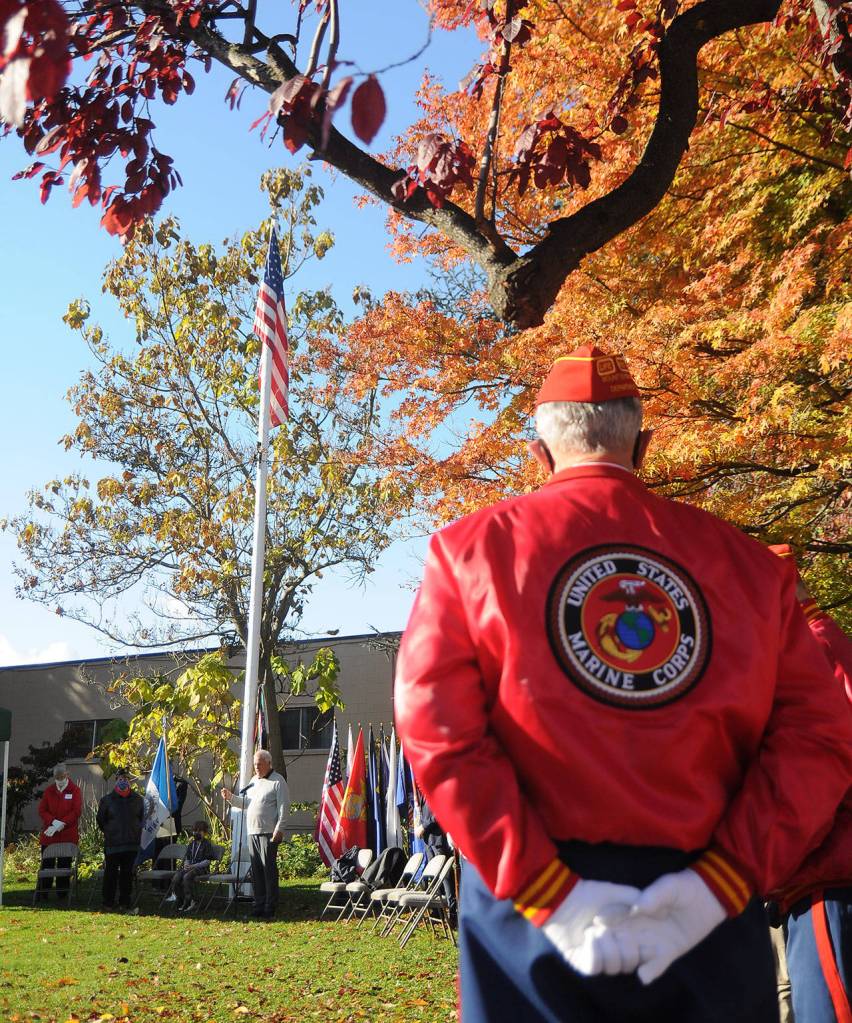 Members of the Marine Corp Leagues Mt. Olympus Detachment listen as Tom Ferrell, veteran and City of Sequim deputy mayor, addresses a Veterans Day ceremony crowd at Pioneer Memorial Park on Wednesday. (Michael Dashiell/Olympic Peninsula News Group)