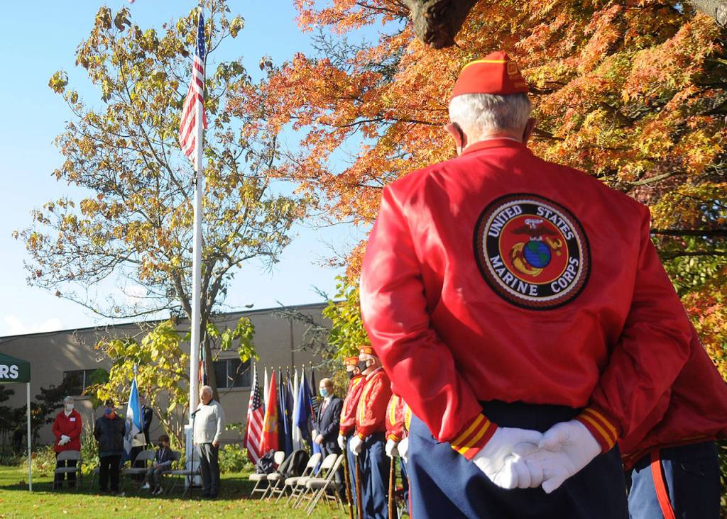 Members of the Marine Corp Leagues Mt. Olympus Detachment listen as Tom Ferrell, veteran and City of Sequim deputy mayor, addresses a Veterans Day ceremony crowd at Pioneer Memorial Park on Wednesday. (Michael Dashiell/Olympic Peninsula News Group)