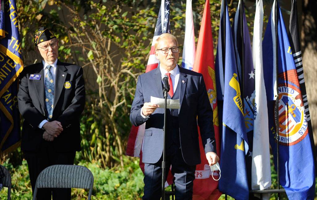 Sequim Mayor William Armacost, right, addresses the crowd at Wednesdays Veterans Day ceremony at Pioneer Memorial park, as emcee Paul Renick, commander of Jack Grennan Post 62 American Legion, listens. (Michael Dashiell/Olympic Peninsula News Group)