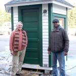 Friends of Fort Worden project lead and board member Bill Appleton, left, stands with local contractor Ty Hodge in front of the nearly completed restored guard shack that used to stand at the entrance of Fort Worden State Park when it was still used by the military. (Zach Jablonski/Peninsula Daily News)