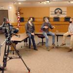Clallam County commissioners, from center left, Bill Peach, Mark Ozias and Randy Johnson take part in an interview with ABC correspondent Zohreen Shah as cameraman Glenn Aust films the proceeding on Friday at the Clallam County Courthouse in Port Angeles. (Keith Thorpe/Peninsula Daily News)